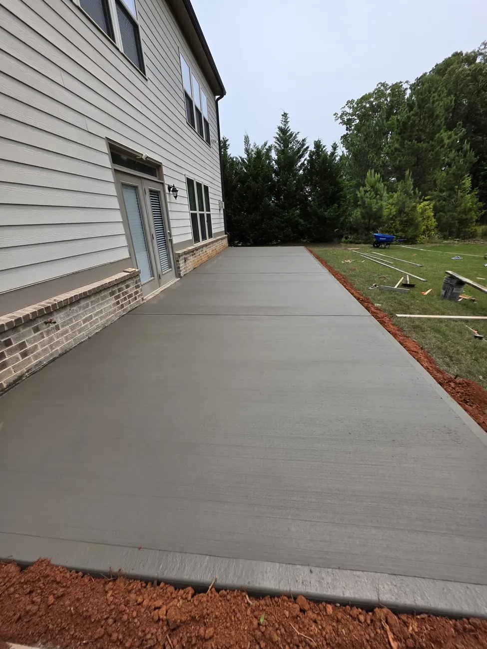 Concrete patios for backyards, under-deck areas, outdoor dining spaces, and cleaner outdoor living.